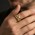 Load image into Gallery viewer, Gold plated Michelangelo Moses spinner band worn on finger, detailed portrait relief on rotating band, premium lifestyle jewelry photo.