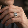 Load image into Gallery viewer, Polished silver mountain landscape band ring on finger, crisp peak engraving and smooth comfort fit, refined everyday wear close-up.