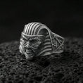 Load image into Gallery viewer, Sterling silver mummy pharaoh mask ring with an oxidized finish, horror-inspired Egyptian face design with ribbed headdress detail, macro on black volcanic rock