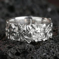 Load image into Gallery viewer, Polished silver oni mask statement ring on black volcanic stone, crisp Japanese demon relief with bold sculpted details, centered close-up studio lighting.
