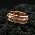 Load image into Gallery viewer, Rose gold plated sterling silver arrow spinner ring on volcanic stone, sculpted arrowhead and wrapped shaft relief with deep contrast, minimal high-end close-up.