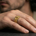 Load image into Gallery viewer, Gold plated Zeus portrait band worn on finger, detailed god face relief with ornate scrollwork, premium lifestyle jewelry photo.