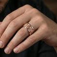 Load image into Gallery viewer, Rose gold plated lion crest band ring worn on finger, sculpted lion head relief medallions with cross motif detail, elegant lifestyle wear shot.