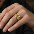 Load image into Gallery viewer, Gold plated lion medallion band worn on finger, detailed lion head relief panels with gothic cross centerpiece, premium lifestyle jewelry photo.