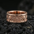 Load image into Gallery viewer, Rose gold plated sterling silver lion crest band on volcanic stone, sculpted lion head relief medallions with ornate cross motif in deep contrast, minimal high-end close-up.