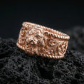 Load image into Gallery viewer, Rose gold plated sterling silver lion signet ring on volcanic stone, sculpted lion head relief with ornate scrollwork and deep contrast, minimal high-end close-up.
