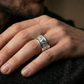 Load image into Gallery viewer, Polished silver wolf Celtic wedding band worn on finger, bright reflective finish with crisp knotwork definition, everyday wear shot.