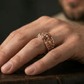 Load image into Gallery viewer, Rose gold plated skull gear band ring worn on finger, elegant warm glow with defined sculpted details and vintage-inspired depth, lifestyle close-up.