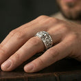 Load image into Gallery viewer, Polished silver skull and gears band worn on finger, clean bright finish with sharp raised relief and smooth comfort edges, everyday wear photo.