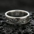Load image into Gallery viewer, Oxidized sterling silver floral scroll band ring on black volcanic stone, vintage darkened grooves emphasizing the minimalist engraved vine pattern.