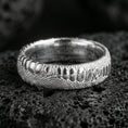 Load image into Gallery viewer, Polished silver snake scale wedding band on volcanic rock, crisp reptile pattern and smooth comfort fit captured in sharp macro detail.