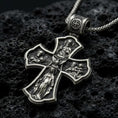 Load image into Gallery viewer, Holy Trinity cross pendant on black volcanic stone with deep oxidized contrast and crisp relief details.