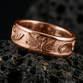 Load image into Gallery viewer, Swan pattern band ring on volcanic stone with a rose gold plated look, showing crisp swan silhouettes and vintage texture.