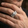 Load image into Gallery viewer, Polished silver rooster ring on a finger, clean reflective edges with high-relief feather carving across the sides.