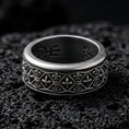 Load image into Gallery viewer, Sterling silver fleur de lis band ring photographed on volcanic rock with oxidized contrast revealing the repeating medieval pattern.
