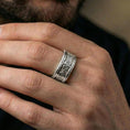 Load image into Gallery viewer, Polished silver filigree band on a finger, clean reflective shine with detailed scroll engraving across the middle section.