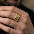 Load image into Gallery viewer, Gold plated ornate scroll ring worn on a finger, warm reflective finish highlighting the engraved curls and decorative borders.