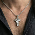 Load image into Gallery viewer, Polished silver Christian cross pendant with side profile Jesus relief and INRI inscription worn on the neck in a close lifestyle frame, highlighting the sculpted detail and sacred symbolism