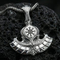 Load image into Gallery viewer, Sterling silver Norse axe necklace pendant in a polished silver finish, sculpted battle axe with Vegvisir runic compass emblem, macro product shot on volcanic stone