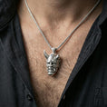 Load image into Gallery viewer, Sterling silver oni mask pendant necklace on the neck, macro lifestyle image showing the polished silver finish and detailed Japanese mask sculpting