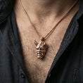 Load image into Gallery viewer, Sterling silver oni mask pendant necklace on the neck, macro lifestyle shot showcasing the rose gold plated finish and carved oni mask features