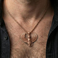 Load image into Gallery viewer, Sterling silver winged Bastet pendant necklace on the neck, macro lifestyle shot showcasing the rose gold plated finish and Egyptian-inspired cat design
