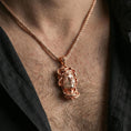 Load image into Gallery viewer, Rose gold plated Medusa head pendant necklace worn on the neck, lifestyle wear shot featuring soft warm metallic glow and detailed serpent crown definition.