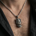 Load image into Gallery viewer, Oxidized Medusa head pendant necklace worn on the neck, lifestyle framing showing realistic scale and the darkened antique contrast on the chest.