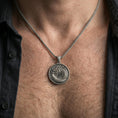 Load image into Gallery viewer, Oxidized oriental dragon medallion pendant necklace worn on the neck, lifestyle framing showing realistic size and bold darkened relief against the chest.