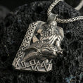 Load image into Gallery viewer, Oxidized Njord Norse sea god pendant necklace on textured volcanic rock, centered close-up highlighting the bearded deity relief, sea-creature motif, rune lettering, and deep antique contrast.