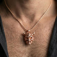 Load image into Gallery viewer, Rose gold plated oni mask pendant necklace worn on the neck, lifestyle wear shot with elegant rosy shine and crisp oni mask engraving visible.