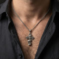Load image into Gallery viewer, Oxidized gothic cross pendant with Only God Can Judge Me inscription worn on the neck in a lifestyle jewelry shot, styled against the chest for a bold and faith-driven look