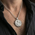 Load image into Gallery viewer, Polished silver Archangel Raphael medallion with angel relief and serpent staff worn on the neck in a close lifestyle frame, highlighting the healing symbolism and detailed circular design