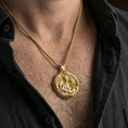 Load image into Gallery viewer, Gold plated Saint Raphael necklace with winged healer motif worn on the neck in a premium lifestyle composition with classic Christian jewelry styling
