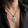 Load image into Gallery viewer, Polished silver Perseus coin pendant necklace worn on the neck, clean lifestyle wear shot capturing bright shine and the detailed winged helmet relief in natural light.