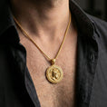Load image into Gallery viewer, Gold plated Perseus coin pendant necklace worn on the neck, lifestyle photo featuring warm tone finish and strong statement medallion presence.