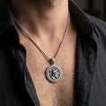Load image into Gallery viewer, Oxidized Perseus coin pendant necklace worn on the neck, lifestyle framing showing realistic scale and bold vintage contrast against the chest.