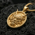 Load image into Gallery viewer, Gold plated demon mask medallion pendant necklace on textured volcanic rock, premium close-up with warm reflective shine across the horns, fierce expression, and raised circular frame.