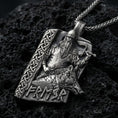 Load image into Gallery viewer, Oxidized Freyr and Gullinbursti pendant necklace on textured volcanic rock, centered close-up highlighting the Viking god relief, boar motif, rune lettering, and deep antique shadowed contrast.