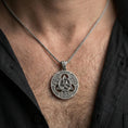 Load image into Gallery viewer, Oxidized Celtic triquetra pendant necklace worn on the neck, lifestyle framing showing realistic scale and bold vintage contrast against the chest.