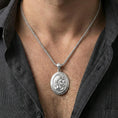 Load image into Gallery viewer, Polished silver Hades coin pendant necklace worn on the neck, clean lifestyle wear shot capturing bright shine and the detailed laurel-crowned profile in natural light.