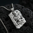 Load image into Gallery viewer, Polished silver Thor pendant necklace on textured volcanic rock, crisp macro product photo emphasizing clean edges, sharp sculpted beard detail, and bright reflective highlights on the hammer and knotwork border.