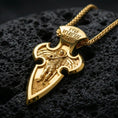 Load image into Gallery viewer, Gold plated Saint Michael pendant with winged protector motif, cross-shaped frame, and engraved inscription showcased on black volcanic rock in a refined macro jewelry image