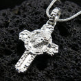 Load image into Gallery viewer, Polished 925 sterling silver Christ crucifix necklace on black volcanic stone with detailed cross texture.