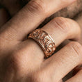 Load image into Gallery viewer, Rose gold plated koi fish band ring worn on a finger, lifestyle wear shot with elegant rosy shine and crisp koi-and-wave detailing visible.