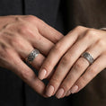 Load image into Gallery viewer, Oxidized Celtic triquetra band ring worn on a finger, lifestyle framing showing realistic scale and bold vintage contrast in a natural hand pose.