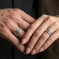 Load image into Gallery viewer, Polished silver Celtic triquetra band ring worn on a finger, clean lifestyle wear shot capturing bright shine and the detailed Trinity knot pattern in natural light.