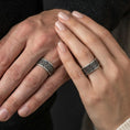 Load image into Gallery viewer, Oxidized geometric knotwork band ring worn on a finger, lifestyle framing showing realistic scale and bold vintage contrast in a natural hand pose.