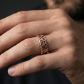 Load image into Gallery viewer, Rose gold plated Celtic triquetra chain-link ring worn on a finger, lifestyle wear shot with elegant rosy shine and crisp linked triquetra detailing visible.