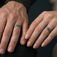 Load image into Gallery viewer, Oxidized diagonal groove band ring worn on a finger, lifestyle framing showing realistic scale and bold vintage contrast in a natural hand pose.
